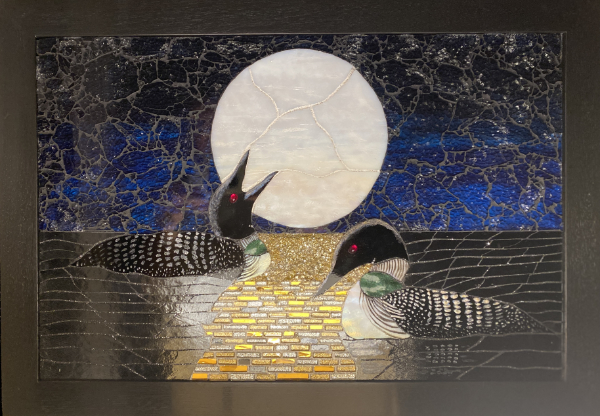 Two loons at night in bright moonlight