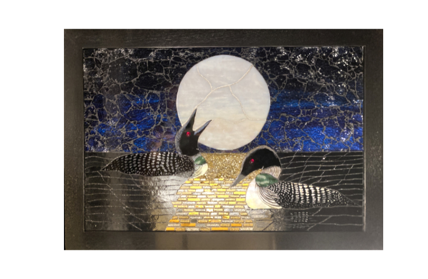 Two loons at night in bright moonlight